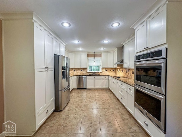 3013 Park Hill Blvd, Jonesboro, AR 72404 - kitchen with stainless steel appliances, backsplash, recessed lighting, a sink, and white cabinets