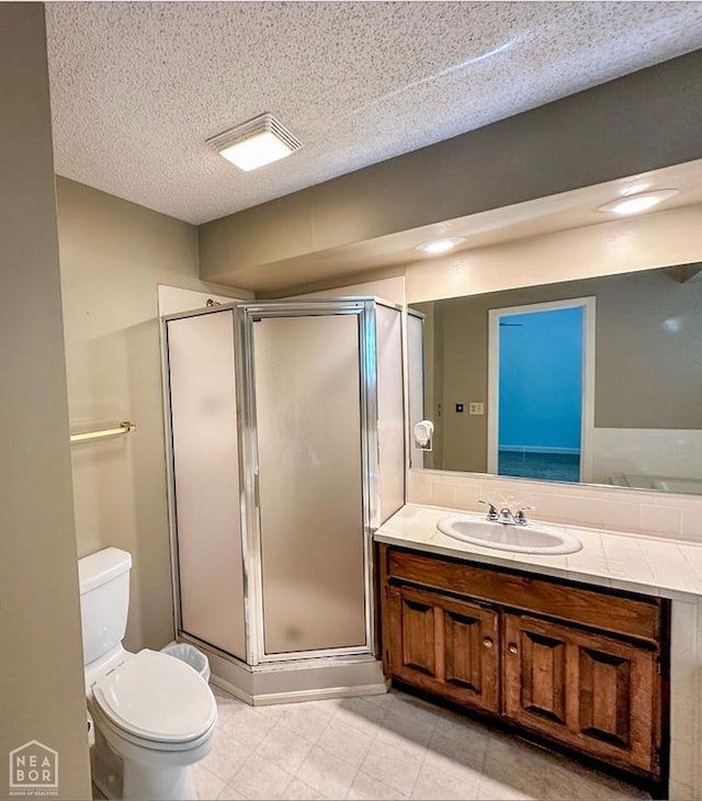 3013 Park Hill Blvd, Jonesboro, AR 72404 - bathroom featuring vanity, tile patterned floors, toilet, a shower stall, and a textured ceiling