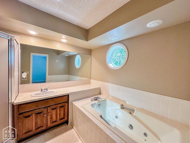3013 Park Hill Blvd, Jonesboro, AR 72404 - bathroom featuring a whirlpool tub, vanity, tile patterned flooring, and a textured ceiling