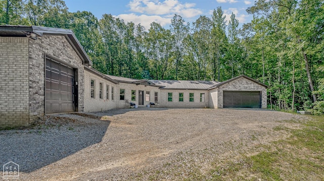 8203 Oak Creek Ln, Harrisburg, AR 72432 - view of front facade with brick siding, driveway, and an attached garage