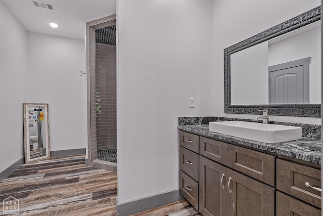 8203 Oak Creek Ln, Harrisburg, AR 72432 - full bath with wood finished floors, vanity, a stall shower, and recessed lighting