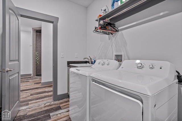 8203 Oak Creek Ln, Harrisburg, AR 72432 - laundry area featuring washer and dryer and wood finished floors