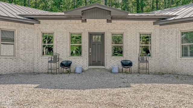 8203 Oak Creek Ln, Harrisburg, AR 72432 - entrance to property with brick siding, a metal roof, and a standing seam roof