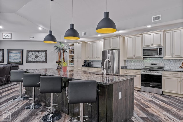 8203 Oak Creek Ln, Harrisburg, AR 72432 - kitchen with appliances with stainless steel finishes, dark wood-style floors, backsplash, a breakfast bar, and lofted ceiling