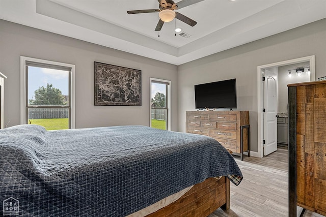 506 S Edmonds St, Monette, AR 72447 - bedroom with light wood-style flooring, a raised ceiling, recessed lighting, ceiling fan, and baseboards