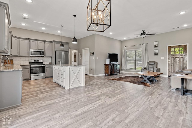 506 S Edmonds St, Monette, AR 72447 - kitchen with stainless steel appliances, gray cabinetry, open floor plan, light wood-style flooring, and recessed lighting