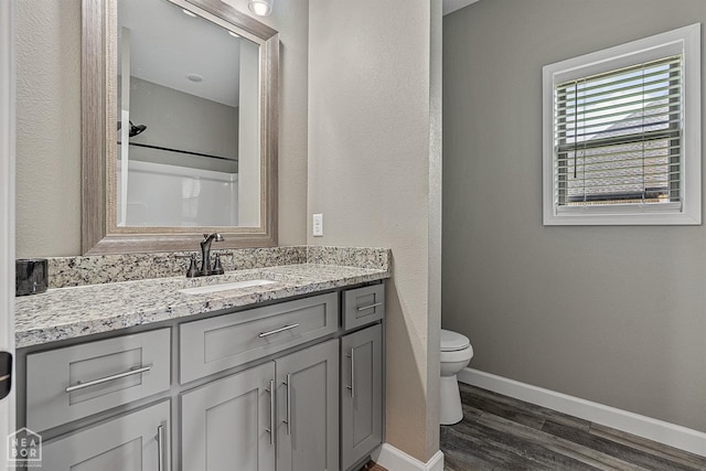 506 S Edmonds St, Monette, AR 72447 - full bath with vanity, toilet, wood finished floors, baseboards, and a shower