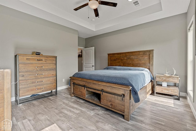 506 S Edmonds St, Monette, AR 72447 - bedroom featuring a raised ceiling, wood finished floors, baseboards, and a ceiling fan