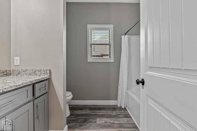 506 S Edmonds St, Monette, AR 72447 - full bathroom featuring wood finished floors, toilet, vanity, shower / bath combo, and baseboards