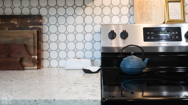 305 Stella Dr, Bono, AR 72416 - kitchen view of stainless steel electric range oven and tasteful backsplash