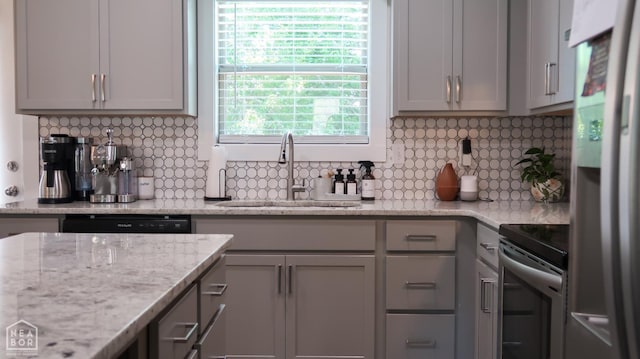305 Stella Dr, Bono, AR 72416 - kitchen with stainless steel appliances, backsplash, gray cabinetry, and light stone counters