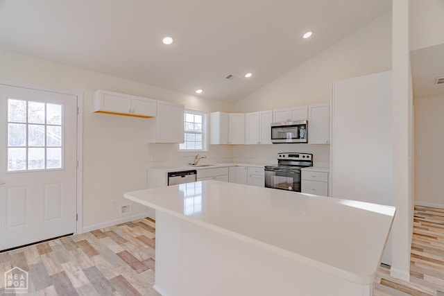 2516 Rebecca Dr, Pocahontas, AR 72455 - kitchen with appliances with stainless steel finishes, white cabinets, recessed lighting, light countertops, and lofted ceiling