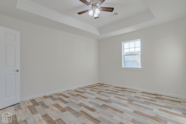 2516 Rebecca Dr, Pocahontas, AR 72455 - unfurnished room with a raised ceiling, light wood-type flooring, and ceiling fan
