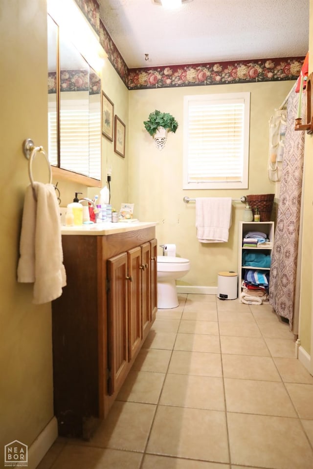 full bath featuring toilet, baseboards, tile patterned flooring, and vanity