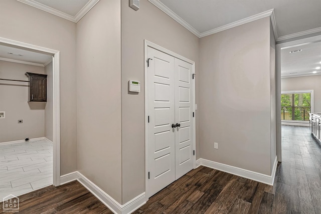 corridor featuring baseboards, ornamental molding, and dark wood-style floors