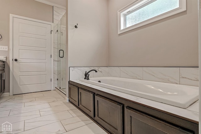 bathroom featuring a bath, marble finish floor, and a shower stall