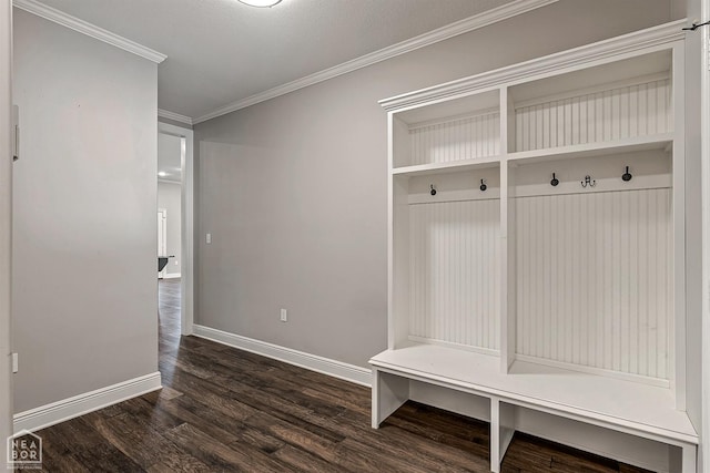 mudroom featuring crown molding, dark wood-style flooring, and baseboards