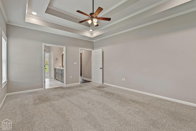 unfurnished bedroom featuring light colored carpet, multiple windows, and ornamental molding