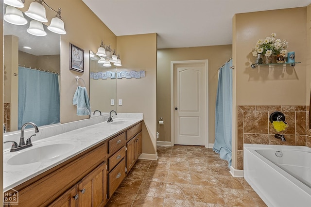 bathroom featuring double vanity, baseboards, a sink, and a bath