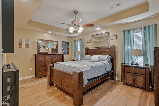 bedroom with multiple windows, light wood-type flooring, and visible vents