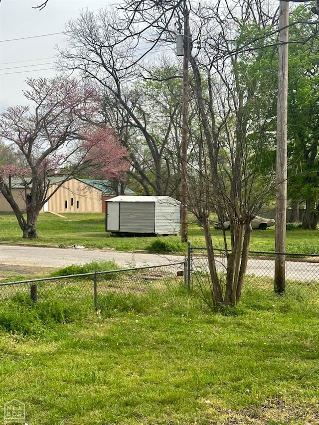 315 Arrington St, Newport, AR 72112 - view of yard featuring fence, an outdoor structure, and a shed
