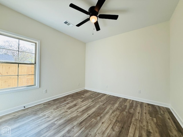 unfurnished room featuring visible vents, baseboards, ceiling fan, and wood finished floors