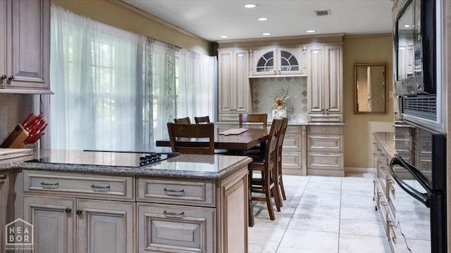 kitchen with light tile patterned floors, crown molding, black electric stovetop, backsplash, and stone countertops