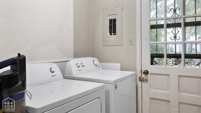 clothes washing area featuring washing machine and dryer, laundry area, and electric panel