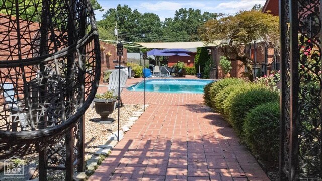 view of swimming pool with a patio and a fenced in pool