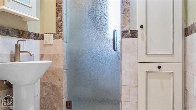 full bath with a shower stall and tile walls