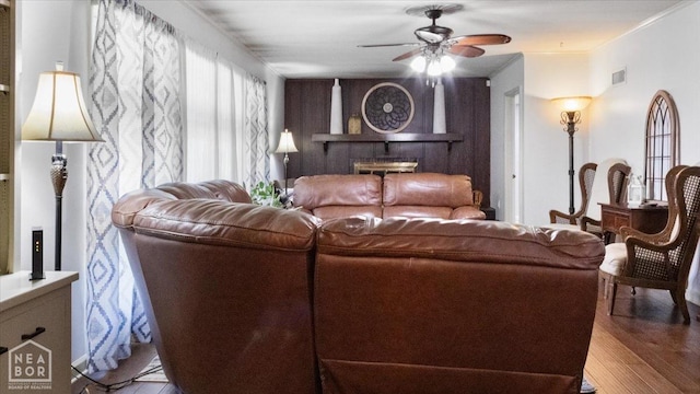 living room with visible vents, ceiling fan, and wood finished floors