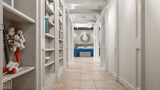 hall featuring light tile patterned floors and built in features