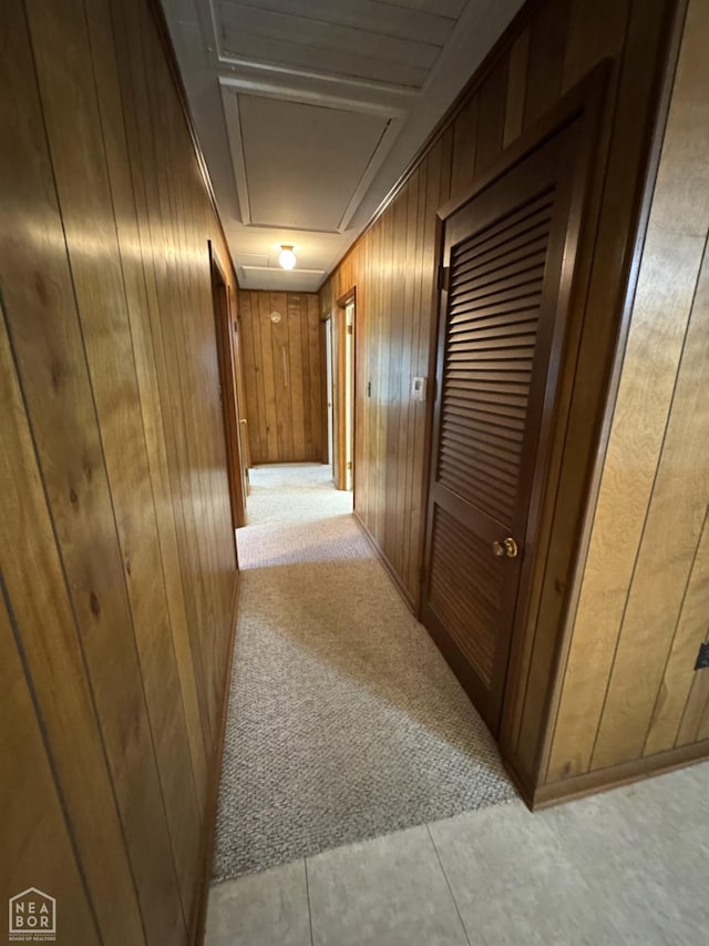 937 Homecrest Dr, Piggott, AR 72454 - hall with attic access, wood walls, and light colored carpet