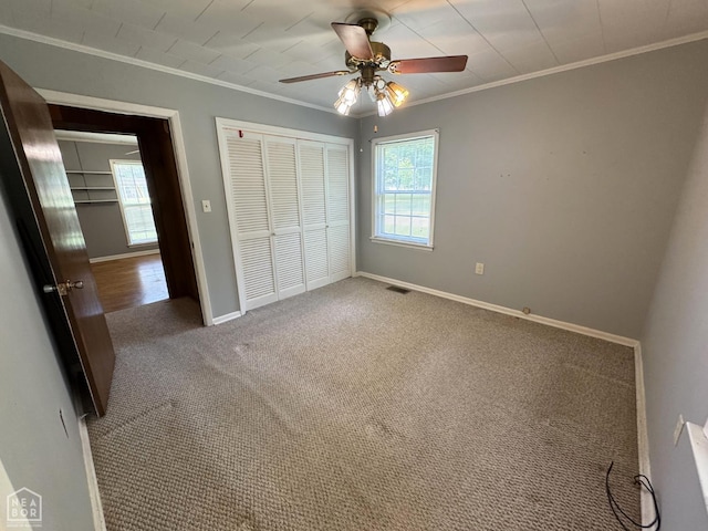 937 Homecrest Dr, Piggott, AR 72454 - unfurnished bedroom featuring crown molding, a closet, carpet, and ceiling fan