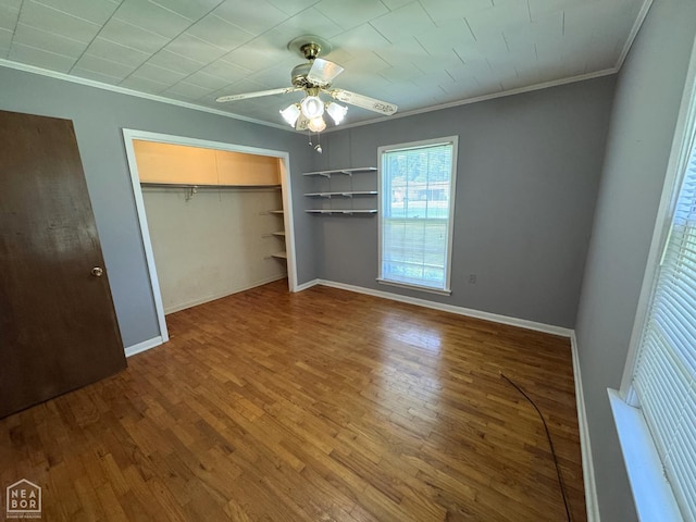 937 Homecrest Dr, Piggott, AR 72454 - unfurnished bedroom featuring crown molding, wood finished floors, a closet, and a ceiling fan