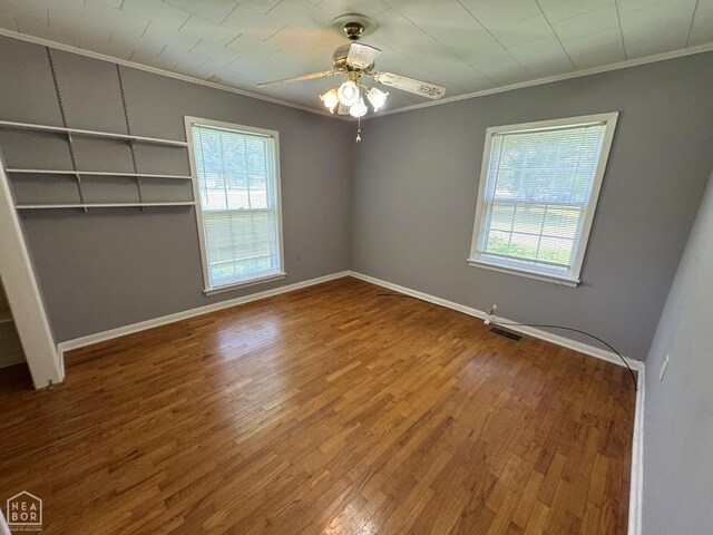 937 Homecrest Dr, Piggott, AR 72454 - unfurnished room with ornamental molding, plenty of natural light, wood finished floors, and ceiling fan