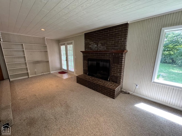 937 Homecrest Dr, Piggott, AR 72454 - unfurnished living room featuring healthy amount of natural light, carpet floors, a fireplace, wooden walls, and wood ceiling