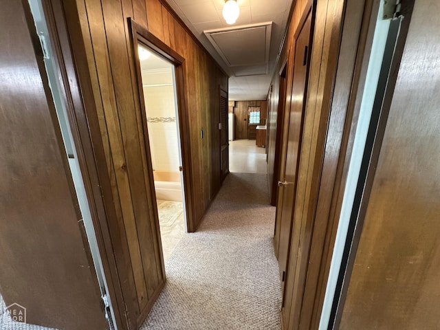 937 Homecrest Dr, Piggott, AR 72454 - corridor featuring attic access, light colored carpet, and wooden walls