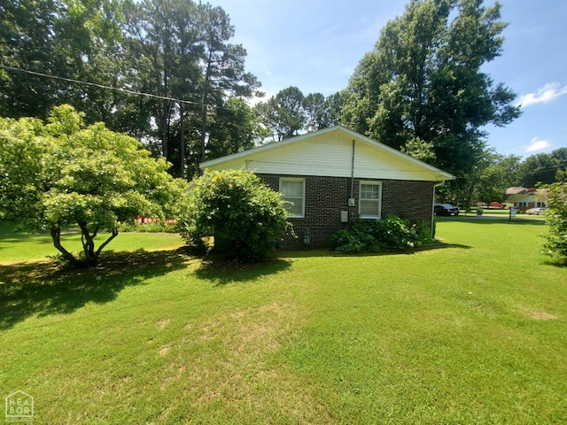 937 Homecrest Dr, Piggott, AR 72454 - view of side of home with a lawn and brick siding