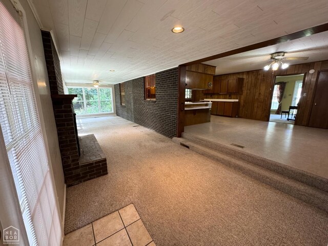 937 Homecrest Dr, Piggott, AR 72454 - hall featuring light carpet, wooden walls, wood ceiling, and light tile patterned floors