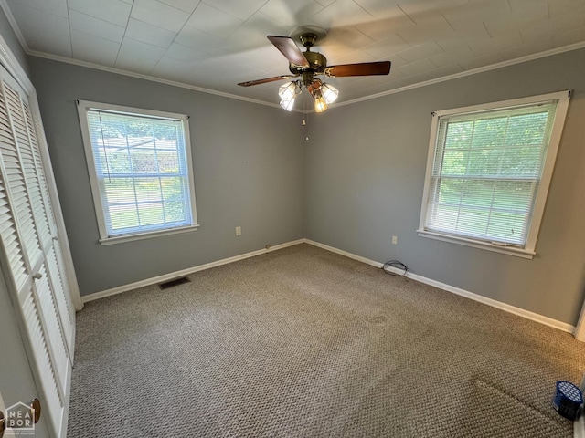 937 Homecrest Dr, Piggott, AR 72454 - unfurnished bedroom featuring ornamental molding, multiple windows, carpet flooring, a closet, and a ceiling fan