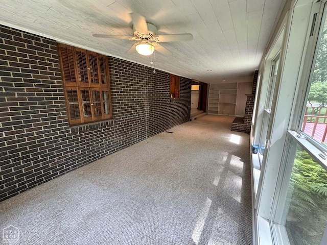 937 Homecrest Dr, Piggott, AR 72454 - spare room featuring brick wall and a ceiling fan