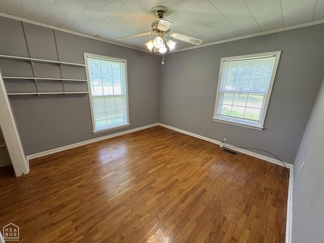 937 Homecrest Dr, Piggott, AR 72454 - unfurnished room with ornamental molding, plenty of natural light, wood finished floors, and ceiling fan