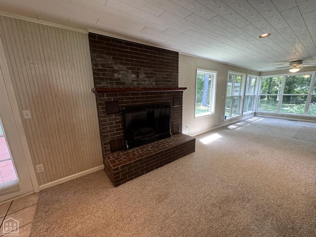 937 Homecrest Dr, Piggott, AR 72454 - unfurnished living room featuring a fireplace, wood walls, carpet floors, crown molding, and a ceiling fan
