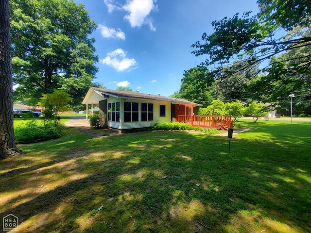 937 Homecrest Dr, Piggott, AR 72454 - back of house with a deck, a yard, and a sunroom