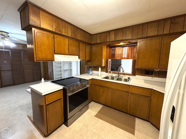 937 Homecrest Dr, Piggott, AR 72454 - kitchen featuring electric stove, under cabinet range hood, brown cabinets, and wooden walls