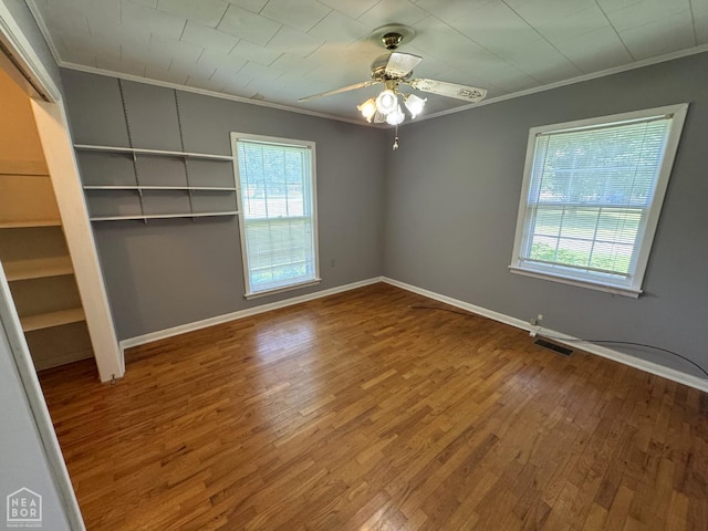 937 Homecrest Dr, Piggott, AR 72454 - empty room with crown molding, wood finished floors, and ceiling fan