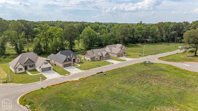 aerial view featuring a wooded view and a residential view