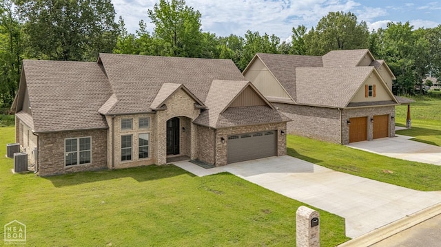 view of front of house with a front yard, brick siding, driveway, and an attached garage