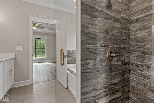 full bathroom featuring ornamental molding, a tile shower, ceiling fan, and vanity